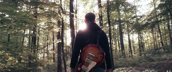 Guitar Player in the Woods