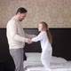 Happy Family Child Daughter and Dad Holding Hands Jumping on Bed - VideoHive Item for Sale