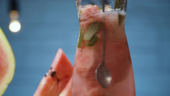 Stirring watermelon lemonade