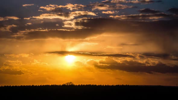 Timelapse of a Bright Orange Sunset with Floating Clouds in the Sky