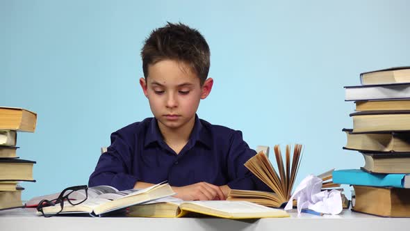 Tired Boy Begins To Close and Fold the Book. Blue Background