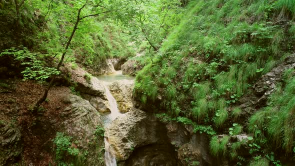 Aerial view of small waterfalls surrounded by a lot of vegetation in Soca river.