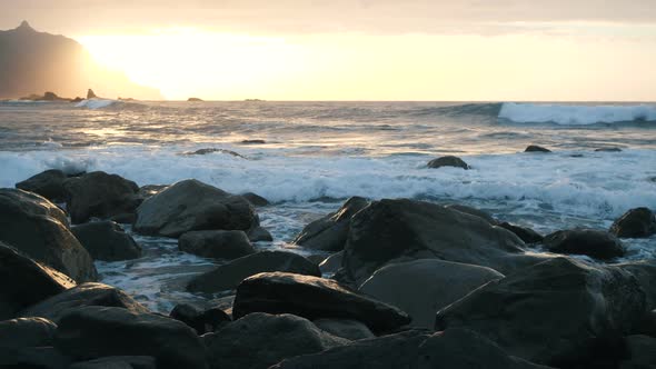 Ocean Waves Crash on Rocks and Spray in Beautiful Sunset Light at Benijo Beach in Tenerife, Canary