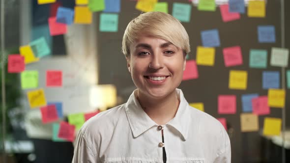 Portrait of Beautiful Young Woman with Blond Hair Wearing Yellow Sweater Looking Up To the Camera