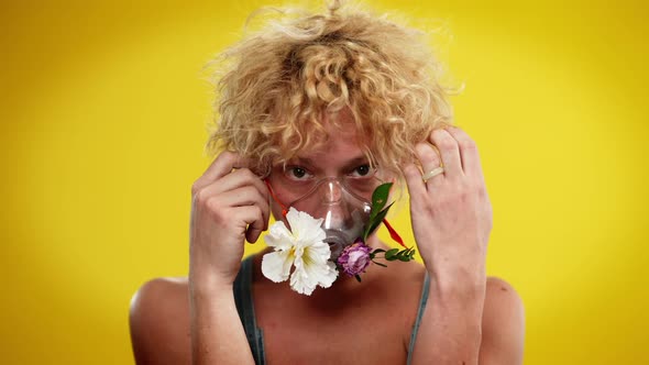 Front View Portrait of Young Caucasian Queer Man with Flowers in Nebulizer Mask