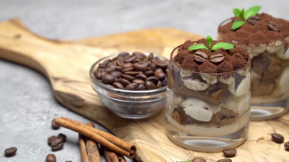 Classic Tiramisu Dessert in a Glass on Dark Concrete Background