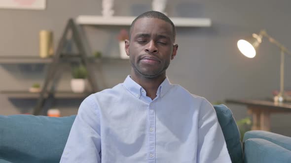 Portrait of African Man Crying Towards the Camera Sofa