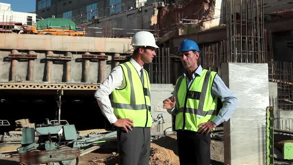 Mature men meeting on construction site