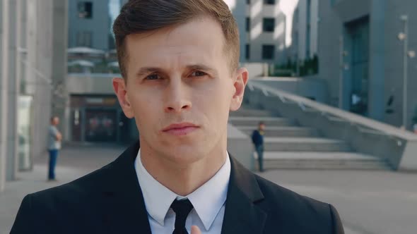 Close Up Attractive Man in Business Suit in Looking Into Camera in the City on Downtown District