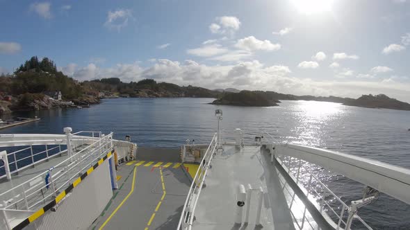 Sailing electric ferry Hjellestad in beautiful sunny weather along Norway coastline - Camera facing