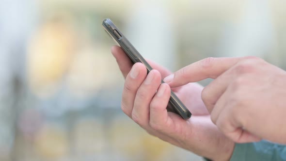 Close up of Man Browsing on Smartphone
