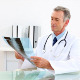 Mature Doctor Examining At Xray At His Desk - VideoHive Item for Sale