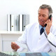 Mature Doctor Talking On The Phone At His Desk - VideoHive Item for Sale