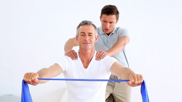 Physiotherapist Watching Patient Stretching Band 1 alt