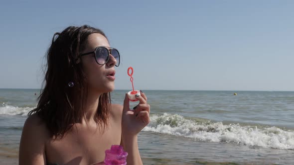 Caucasian brunette blowing soap bubbles 4K 3840X2160 UHD video - Young  female playing with air-bubb