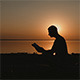 Man Reading a Book at Sunset on the Lake - VideoHive Item for Sale