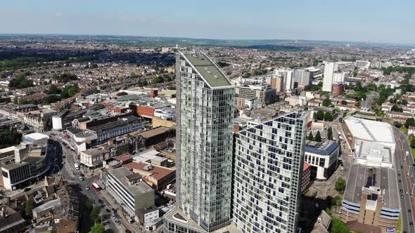 Reverse aerial view of the two tall buildings in Ilford, London on a sunny day