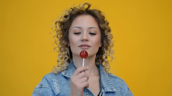 Face of Beautiful Young Woman with Lollipop