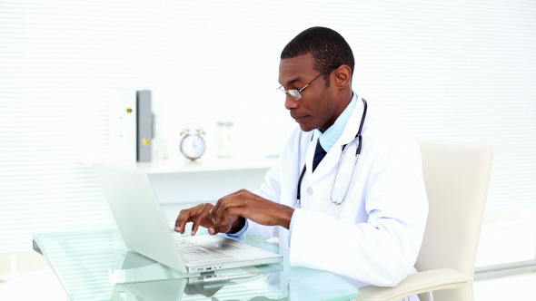 Concentrating Doctor Working On His Laptop