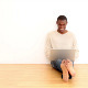 Smiling Man Using Laptop Sitting On The Floor - VideoHive Item for Sale