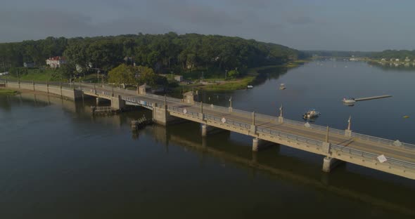 Aerial Pan of a Small Bridge and Boats Anchored at Water