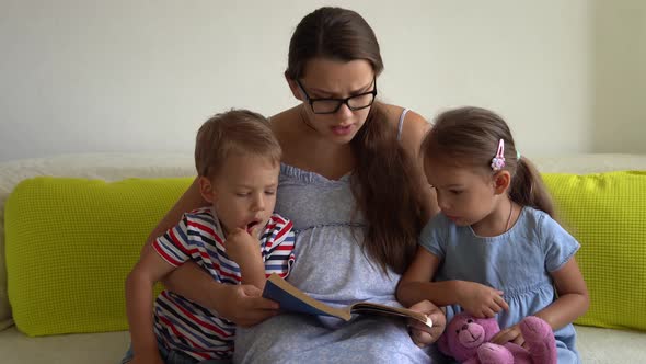 Pregnant Woman Feeling Happy At Home Taking Care of Child on Sofa