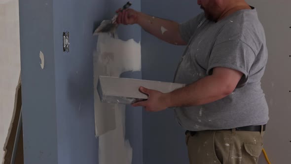 Handyman Using Tool Plastering for Finishing Old Wall