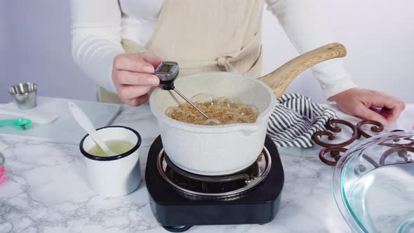 Time lapse. Step by step. Mixing in food flavor into caramelized sugar to make homemade lollipops