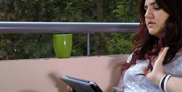 Young Girl Playing with Tablet Computer alt