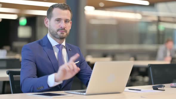 No Gesture with Finger By Middle Aged Businessman at Work