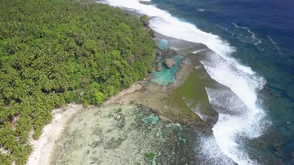 Aerial wide dolly of Magpupungko Rock Pools and jungle in Siargao, the Philippines