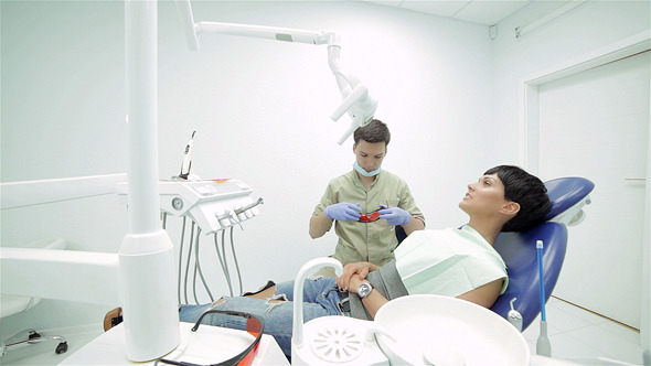 Dentist Turns On The Lamp, And Treats Teeth
