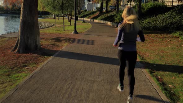 Athletic Woman Jogging In The Park