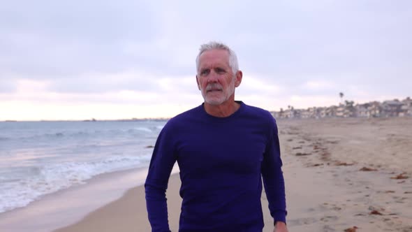 Mature Man Exercising At The  Beach