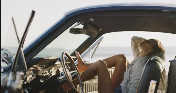 Beautiful woman sitting in a vintage car