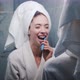 Young Beautiful Woman in the Bathroom Brushing Her Teeth in Front of the Mirror - VideoHive Item for Sale