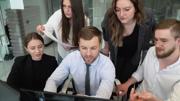 Confident Smart Manager Explaining Corporate Software Details to Motivated Colleagues