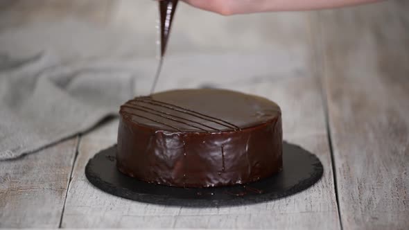 Chef Decorate the Cake with Melted Chocolate