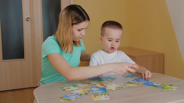 Cute Pretty Child with Young Mother Pick Puzzle Detail Learning and Studying