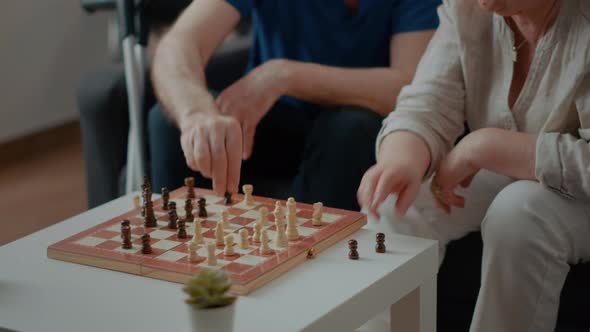 Intellectual People Playing Chess Game with Pieces and Board