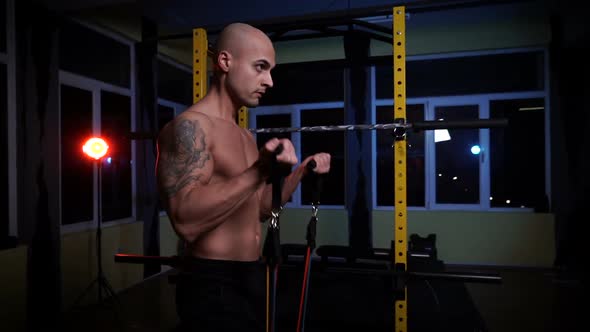 Shirtless Bodybuilder Training Biceps Muscles