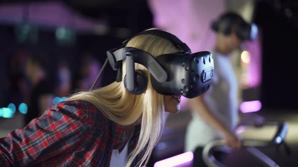 Modern Interactive Technologies, Female in Glasses of Virtual Reality Playing a Arcade Game.