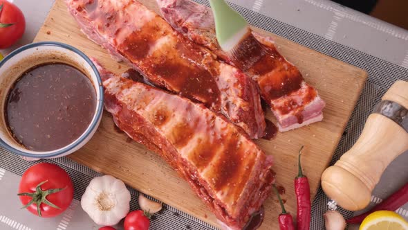 Ribs Get Glazed with Brush with Sweet Barbeque Sauce in Slow Motion Closeup