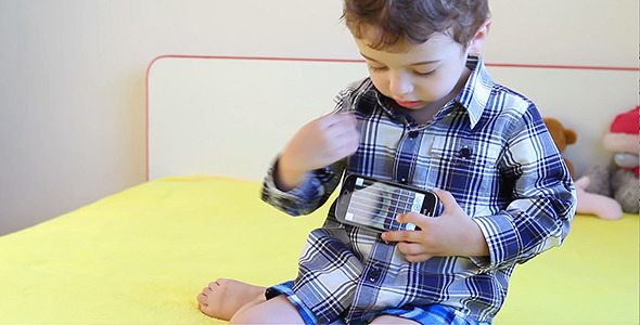Little Boy Playing with Smart Phone 1