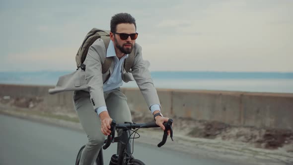 Businessman In Suit Riding On Bicycle. Trip To Work On Bike. Cyclist Businessman Hurry To Work.