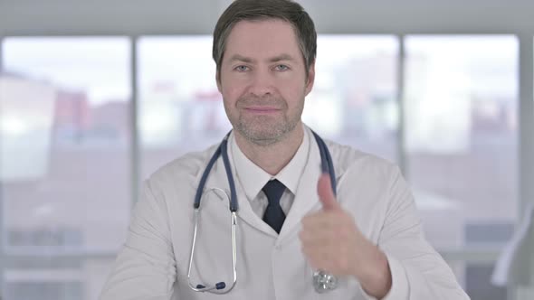 Portrait of Middle Aged Doctor Showing Thumbs Up