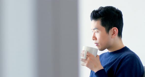 Man using digital tablet while having cup of coffee 4k