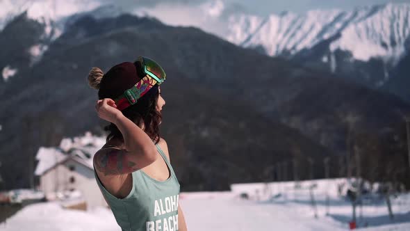 Portrait of Pretty Asian Woman in Blue Swimsuit Run and Snowboard Goggles at Winter Ski Resort at