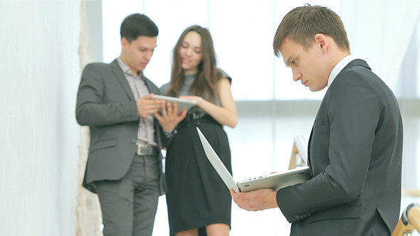 Young and Successful Businessman Holding a Laptop