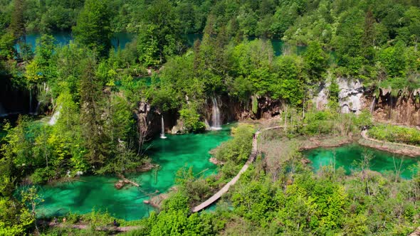 Aerial view of flowing waterfall in turquoise water lakes in Croatian national park. Summer leisure